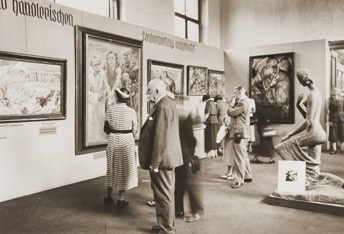 Visitors view the Degenerate Art exhibition, with Der Turm der Blauen Pferde visible on the right